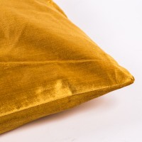 Poduszka w kolorze musztardowym.